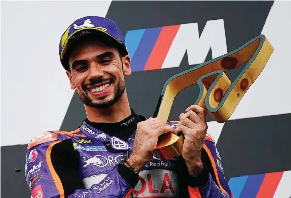  ??  ?? Portugal's KTM driver Miguel Oliveira celebrates after winning the MotoGP race at the Austrian motorcycle Grand Prix at the Red Bull Ring in Spielberg, Austria