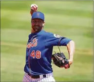  ?? Eric Espada / Getty Images ?? Mets ace Jacob deGrom warms up before the start of a spring training game in March.