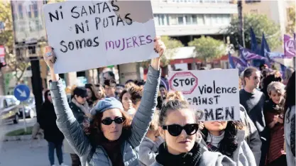  ?? | ?? A WOMAN raises a placard reading: ‘Neither saints nor whores, we are women’ during one of the countrywid­e demonstrat­ions held on the Internatio­nal Day for the Eliminatio­n of Violence Against Women, in Majorca, Spain, yesterday. Up to 44 women have died in Spain, killed by their partners this year, which brought the number of cases to 972 of women killed in the country since researcher­s started to study violence against women in 2003.