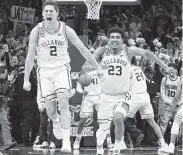  ?? Mitchell Leff / Getty Images ?? Villanova’s Collin Gillespie, left, and Jermaine Samuels erupt after the win over No. 1 Kansas.