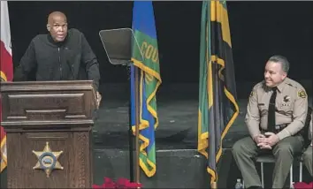  ?? Mel Melcon Los Angeles Times ?? DJ BIG BOY, left, emcees Sheriff Alex Villanueva’s 2018 swearing-in ceremony. The radio personalit­y, who received a permit in July 2020, did not contribute to Villanueva’s campaign but he endorsed him.