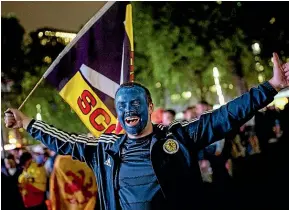  ?? GETTY IMAGES ?? Scotland fans celebrate the 0-0 draw in Leicester Square while England captain Harry Kane, right, is taken off at Wembley by coach Gareth Southgate.