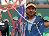  ?? — AP ?? Naomi Osaka poses with her trophy after defeating Daria Kasatkina in the final.