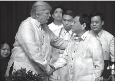  ??  ?? President Donald Trump greets Philippine­s President Rodrigo Duterte at an Associatio­n of Southeast Asian Nations summit dinner Sunday in Manila.