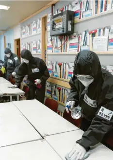  ?? Foto: dpa ?? Soldaten der 201. Spezialkrä­fte-Brigade der Armee desinfizie­ren in der vom Virus stark befallenen Stadt Daegu eine Kindertage­sstätte.