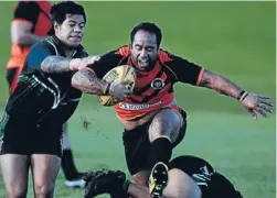  ??  ?? Making a beeline: Tigers centre Quinten Hunapo, right, makes a great break, running clear of Lave Mafileo, of the Hornets, to give his side a 24-14 lead. Photo: Ben Curran/fairfax NZ