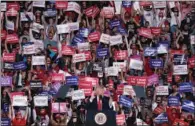  ?? (AFP) ?? Attendees cheer and hold up signs as President Donald Trump speaks at a campaign rally on Friday in Macon, Georgia.