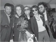  ?? ASSOCIATED PRESS ?? Steve Harley, center, and his band, Cockney Rebel at London’s Heathrow airport in 1975, on their arrival from America.