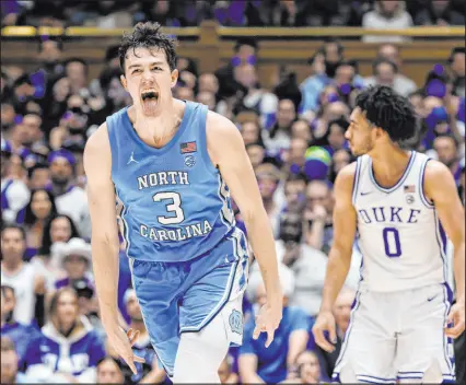  ?? Ben Mckeown
The Associated Press ?? North Carolina guard Cormac Ryan exults in front of Duke guard Jared Mccain after sinking one of his six 3-pointers Saturday in the Tar Heels’ win at Cameron Indoor Stadium. Ryan scored 31 points.