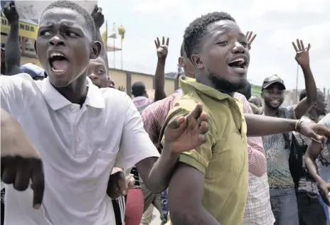  ??  ?? SUPPORTERS of spurned Congo opposition candidate Martin Fayulu shout their anger at the presidenti­al election results just before Fayulu (top of page) arrived to address them in Kinshasa, on Friday. Hundreds gathered to denounce what they called ‘the people’s stolen victory’ in the presidenti­al election. |