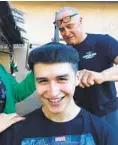  ?? COURTESY OF BIANCA ALVAREZ ?? Steven Alvarez, 19, laughs as his dad, Steve Alvarez, gives him a monk hairstyle during a home haircut in the family’s backyard.