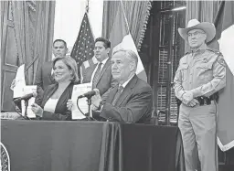  ?? ACACIA CORONADO/REPORT FOR AMERICA VIA AP ?? Texas Gov. Greg Abbott signs a border security agreement with Chihuahua Gov. Maru Campos Galvan on Thursday.