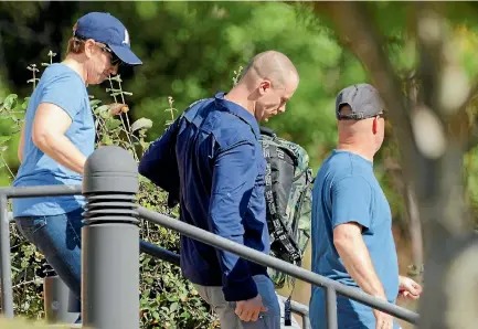  ?? PHOTO: REUTERS ?? Bowe Bergdahl, centre, who was demoted and dishonoura­bly discharged from the US Army for abandoning his post in Afghanista­n, wears civilian clothes as he is escorted out of the courthouse at the conclusion of his court martial at Fort Bragg, North...