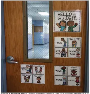  ?? (Arkansas Democrat-Gazette/Thomas Metthe) ?? Signs on a classroom door at Chicot Elementary School in Little Rock illustrate different ways for students to greet one another. Students and staff members will enter a new world of education when classes around the state start Monday.