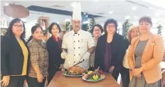  ??  ?? Chef Hashim Daud (centre) getting ready to carve the Christmas turkey for his appreciati­ve diners from SWWS. Also seen here are the team from the hotel.