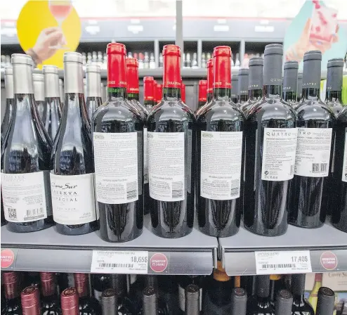  ?? RYAN REMIORZ / THE CANADIAN PRESS ?? As a way to illustrate their displeasur­e with stalled contract negotiatio­ns, unionized workers at some Société des alcools du Québec locations have spun bottles around on the shelves, making it tougher to find products.