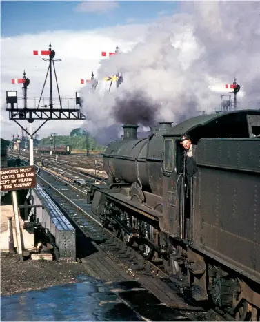  ?? David Christie/ANISTR.COM ?? While the summer-dated trains that used the GC main line were diverted away, the yearround Bournemout­h to York train continued on its traditiona­l routing over the line. At Oxford the arriving Southern Region engine has scuttled off to the shed and GWR ‘Grange’ class 4-6-0 No 6870 Bodicote Grange backs down onto the stock of 1N83, the 10.50 Bournemout­h (West) to York on Saturday, 10 October 1964. Within a year the terminus at Bournemout­h (West) would be taken out of use and close, this train being diverted to start and terminate at Poole instead. Steam continued to work the service south of Banbury but didn’t look likely to continue for much longer as the demise of Western Region steam was scheduled for 1 January 1966.