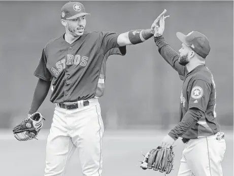 ?? Karen Warren / Houston Chronicle ?? Carlos Correa, left, has said he is willing to play third in the World Baseball Classic for Team Puerto Rico, whose roster includes Gold Glove shortstop Francisco Lindor of the Cleveland Indians. Jose Altuve, right, will man his customary second base...