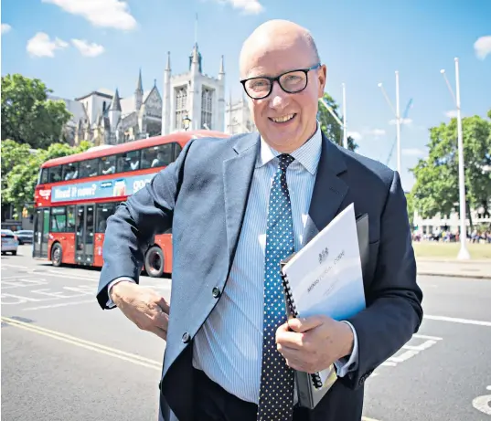  ?? ?? Lord Geidt holds a copy of the ministeria­l code after his select committee appearance. His resignatio­n came, he said in a letter to Boris Johnson, after he was put in ‘an impossible and odious position’