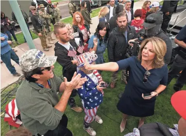  ?? PHOTOS BY DAVID WALLACE/THE REPUBLIC ?? Arizona Republican Party Chair Kelli Ward puts her hand in the face of a man who was yelling at her for signing off on a certificat­e of accuracy for Maricopa County voting machines.
