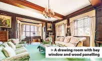  ?? ?? > A drawing room with bay window and wood panelling