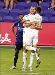  ?? JOHN RAOUX / ASSOCIATED PRESS ?? Adam Jahn celebrates Saturday night’s goal with Brooks Lennon. “The key for us is to keep believing in ourselves,” Jahn said. “And eventually they’ll start falling and we’ll get on a roll here.”