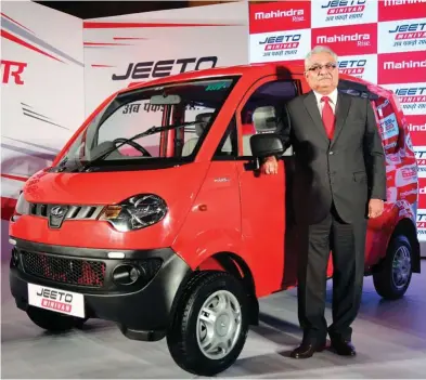  ??  ?? ⇧ Rajan Wadhera, President, Automotive Sector, Mahindra & Mahindra, with the Jeeto minivan.