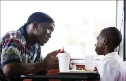  ?? DAVID BORNFRIEND/A24 VIA AP ?? Mahershala Ali, left, and Alex Hibbert in a scene from, “Moonlight.” Ali is nominated for an Oscar for best supporting actor for his work in “Moonlight.”