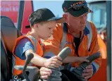  ??  ?? Daniel Colliver, 5, tries to pick up a drink bottle using Doug the Digger at the Central Districts Field Days.