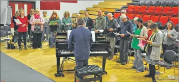  ?? 01_B18choir02 ?? Choir leader James O’Neil sings and plays the piano during the chorus of Gloria Gaynor’s I Will Survive.