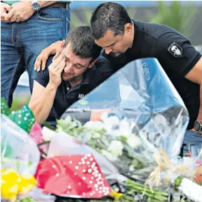  ??  ?? Pc Andrew Harper with his wife Lissie, who wrote an open letter to him yesterday. Right, a police officer is overcome with emotion as he views the tributes at the murder scene