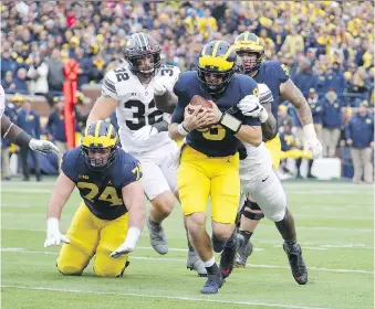  ?? GREGORY SHAMUS/GETTY IMAGES ?? John O’Korn of the Michigan Wolverines during action against rival Ohio State Buckeyes on Saturday in Ann Arbor. The Buckeyes continued their mastery over Michigan with a 31-20 victory.