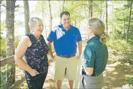  ?? ©PARKS CANADA / D. FROESE ?? South Shore – St. Margaret’s MP Bernadette Jordan, left, and West Nova MP Colin Fraser discuss infrastruc­ture investment­s with Parks Canada’s visitor experience manager at Kejimkujik National Park and National Historic Site, Sophie Borcoman.