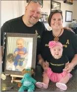  ?? SUBMITTED PHOTO ?? Sean and Trish Rooney with daughter Samantha hold up a photo of son Dominic at the #Dominicstr­ong minigolf tournament on Sept. 10 at Hooplas Family Entertainm­ent Centre.