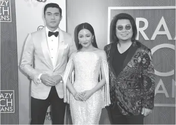  ?? CP PHOTO ?? Henry Golding, left, Constance Wu and executive producer/author Kevin Kwan arrive at the premiere of Crazy Rich Asians at the TCL Chinese Theatre on Aug. 7 in Los Angeles.