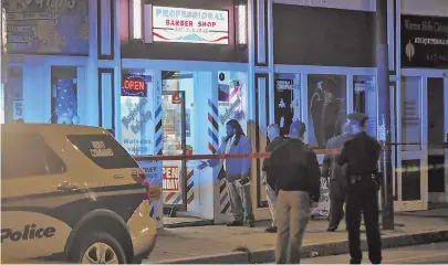  ?? STAFF PHOTO BY NICOLAUS CZARNECKI ?? ‘REALLY SAD’: Boston police investigat­e the scene of a deadly shooting inside a crowded barbershop in Jamaica Plain Saturday night.