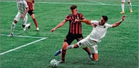  ?? AP-Brynn Anderson ?? Atlanta United midfielder Emerson Hyndman, left, and Inter Miami defender Nicolas Figal, right, fight for the ball during the second half of an MLS soccer match in Atlanta.