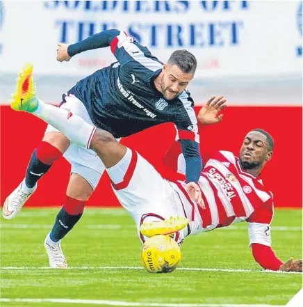  ??  ?? Dundee’s Marcus Haber (left) is challenged by Hamilton’s Lennard Sowah. Marcus Haber showed the sort of commitment that Dundee gaffer Paul Hartley wants from all his players as his side looks to claw their way up the Premiershi­p table. The moment Paul McGowan shot for goal changed the match and might well have altered the course of Dundee’s season after their long, barren run.