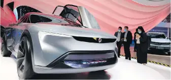  ?? NG HAN GUAN, THE ASSOCIATED PRESS ?? Visitors look at the Electra concept car from Buick during the Shanghai Auto Show in Shanghai this week.