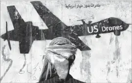  ?? Yahya Arhab European Pressphoto Agency ?? IN SANA, graffiti reflects the realities in Yemen. People in the village of Yakla said they heard the buzzing of drones before the deadly U.S. raid began Jan. 29.