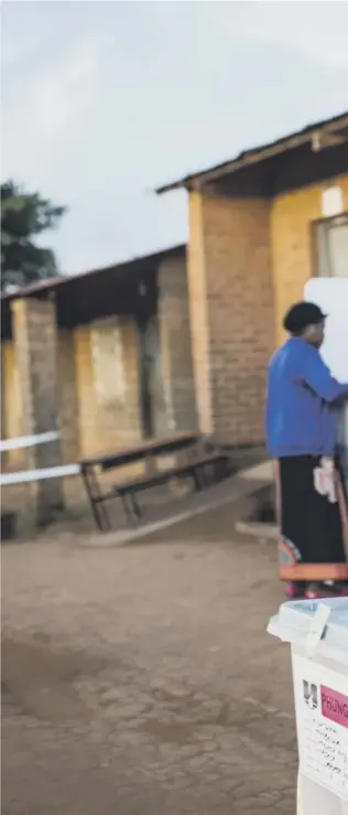  ??  ?? 0 A woman casts her vote at Masasa Primary School polling station in Mzuzu
