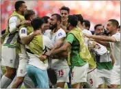  ?? FRANCISCO SECO — THE ASSOCIATED PRESS ?? Iran's Rouzbeh Cheshmi, center, celebrates with teammates after scoring a goal in stoppage time against Wales.