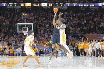  ?? WADE PAYNE AP ?? Missouri’s Deandre Gholston makes a last-second 3-point shot over Tennessee’s Jahmai Mashack to win it.