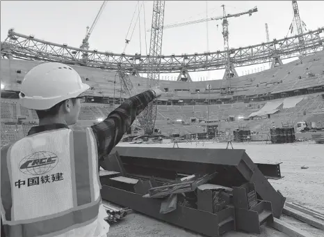  ?? XINHUA ?? A CRCC employee works at Lusail Stadium, where the final match of the 2022 FIFA World Cup will be held, in Doha, Qatar. The project is being undertaken by the State-owned enterprise.