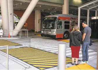  ?? Josie Norris / The Chronicle ?? A Muni bus pulls out of the reopened Transbay transit center Sunday, the first day it reopened to buses after nearly a year of repairs. Monday was the center’s first weekday commute.