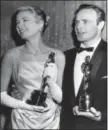  ?? THE ASSOCIATED PRESS ?? Grace Kelly, left, and Marlon Brando, hold their best actress and actor Oscars in Los Angeles. Kelly’s icy green satin gown was designed by Edith Head.