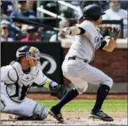  ?? FRANK FRANKLIN II - THE ASSOCIATED PRESS ?? New York Yankees’ Brett Gardner follows through on a two-run single during the second inning of a baseball game as Tampa Bay Rays catcher Jesus Sucre, left, watches Wednesday, in New York.