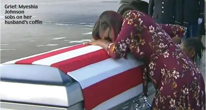  ??  ?? Grief: Myeshia Johnson sobs on her husband’s coffin