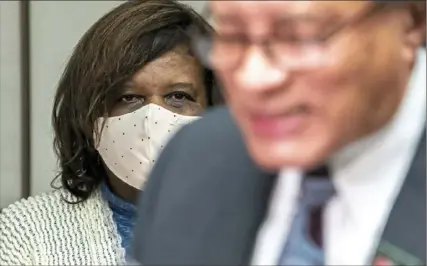  ?? Alexandra Wimley/Post-Gazette ?? Victoria Goins, left, director of the Center for Economic Self Reliance at the Urban League of Greater Pittsburgh, listens as Tim Stevens, chairman and CEO of the Black Political Empowermen­t Project, speaks about police reform Monday in the Hill District.