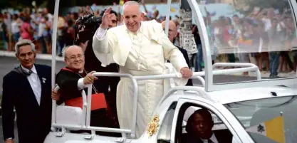  ?? AP ?? THE POPE IN HAVANA People greet Pope Francis on his popemobile as he rides from the airport to downtown Havana after his arrival in Cuba on Saturday.